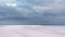 Salt pink lake gray purple high epic clouds on sky