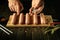 Salt raw meat sausages with the hands of the cook before cooking. Concept for preparing delicious grilled Munich sausages with