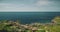 Salt water lake at sea bay with green cliff shore timelapse aerial view of Sumba Island, Indonesia