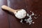 Salt on wooden spoon,food background.