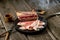 Salted bacon on wooden board with pepper fork knife smoke wooden texture cuisine daylight