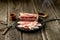 Salted bacon on wooden board with pepper fork knife smoke wooden texture cuisine daylight