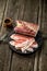 Salted bacon on wooden board with pepper fork knife smoke wooden texture cuisine daylight