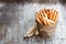 Salted bread sticks with wheat ears on wooden table