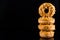 Salted Caramel Donuts or Doughnuts Tower on Dark Background. Copy Space for Text