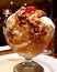 Salted caramel ice cream sundae with candied pecan nuts & cherry on top