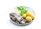Salted herring with boiled potatoes and quial eggs on a white plate isolated on white