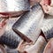 Salted herring cut into chunks.Background of pieces of pickled herring top view.