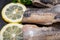 Salted Herring Fillets garnished with Yellow Onion, Lemon, Fresh Parsley and Dried Chili Pepper. Natural black stone background.