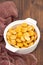 Salted lupins in white bowl on brown wooden background