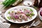 Salted, marinated herring fillet with onion on plate