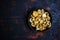 salted milk mushroom. in a black bowl on a black wooden table