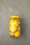 Salted Moroccan lemons in jar. Healthy fermented food. Grey background, copy space