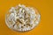 Salted popcorn grains in the box on the orange background