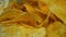 Salted potato chips close-up, full frame. Highly detailed macro video in 4k resolution. Fried potatoes