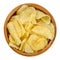 Salted potato chips with peel, also crisps, in wooden bowl