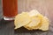 Salted potato ships on old wooden table