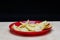 Salted Potato Wafers in Red Dish on Wooden Table, Heap of Wafers, Copy Space, Heap of Chips, Side View,  In Black