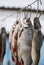 Salted river fish ramming in scales hanging on an iron hook