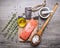 Salted salmon fillet on a cutting board with delicious ingredients for cooking wooden rustic background top view