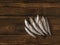 Salted sprat fish on a dark wooden table