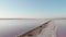 Saltiest estuary in Ukraine, Kuyalnik. Dry mud and salt on shore of Kuyalnik. Wooden posts in salt water. Old piles of jetty on ab