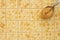 Saltine crackers background with spoon full of peanut butter