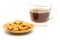 Salty cashew nuts in wooden plate and a cup of coffee