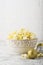 Salty fresh crusty homemade popcorn in cup in the fashion light background of white brick wall in a New Year`s interior