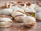 Salty pistachioes on the wooden and blurry background close up