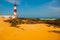 SALVADOR, BAHIA, BRAZIL: Farol De Itapua on the rough sea. Lighthouse on the beach in Sunny weather