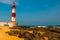 SALVADOR, BAHIA, BRAZIL: Farol De Itapua on the rough sea. Lighthouse on the beach in Sunny weather