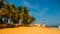 SALVADOR, BAHIA, BRAZIL: Farol De Itapua on the rough sea. Tropical landscape on the beach with palm trees and lighthouse