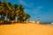 SALVADOR, BAHIA, BRAZIL: Farol De Itapua on the rough sea. Tropical landscape on the beach with palm trees and lighthouse