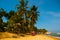 SALVADOR, BAHIA, BRAZIL: Farol De Itapua on the rough sea. Tropical landscape on the beach with palm trees and lighthouse