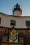 SALVADOR, BRAZIL: Entrance gate. Colorful sign stands in front of the colonial Farol da Barra lighthouse, the oldest in South