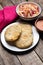 Salvadoran pupusas with coleslaw and tomato sauce on wooden background