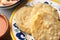 Salvadoran pupusas with coleslaw and tomato sauce on wooden background