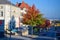 SALZBURG, AUSTRIA - OKTOBER 12, 2018: Road into the distance and a tree with red and green leaves near the house