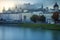 Salzburg peaceful cityscape at misty sunrise from Salzach river, Austria