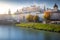 Salzburg peaceful cityscape at misty sunrise from Salzach river, Austria