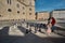 Salzburg, Salzburger Land, Austria - September 11, 2018: Man with a little girl playing huge chess at Kapitelplatz Chapter Square