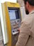 Samara, RUSSIA - AUGUST 26, 2018: bearded middle-aged businessman Caucasian appearance uses a credit card at an ATM Bank