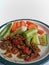 Sambal and lalap, carrot and cucumber as salad, on white background