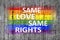 Same Love Same Rights and LGBT flag painted on background texture