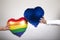 Same sex hands holding two heart shaped balloons on white background. LGBT concept. Valentine`s Day