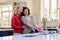 Same Sex Mature Female Couple Doing Washing Up In Kitchen Together