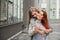 Same-sex relationships. Happy lesbian couple with dried flowers. The girl gently hugs the red-haired girlfriend from