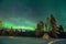 Sami tent under a green northern lights in Lapland