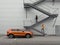 samoa orange SEAT Ateca crossover in front of grey wall